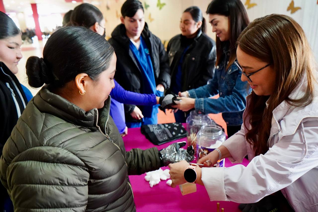 Grupo de jvenes recibe guantes y materiales en una mesa de actividades sensoriales del Foro Somos Diversos del DIF Nuevo Laredo