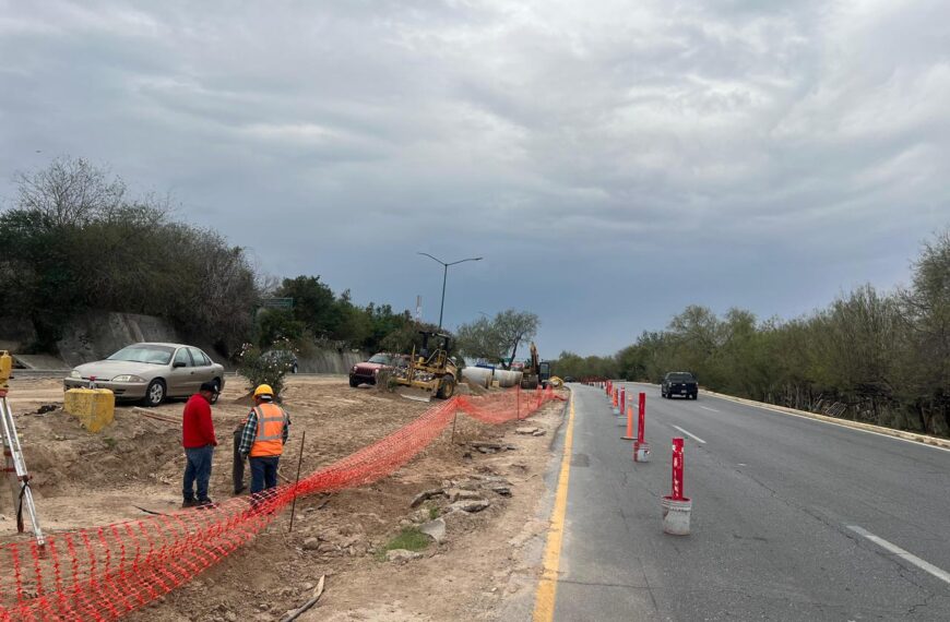 Trabajos de rehabilitación del Colector Ribereño en el bulevar Colosio de Nuevo Laredo con cierre de un carril y maquinaria pesada en operación.