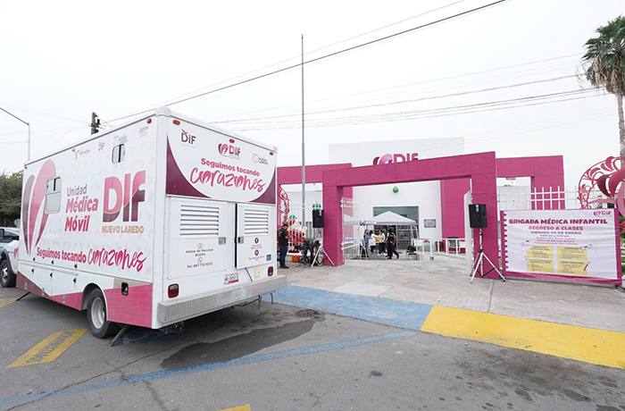 DIF mobile medical unit with pink branding parked near a pink event entrance for a children's health campaign.
